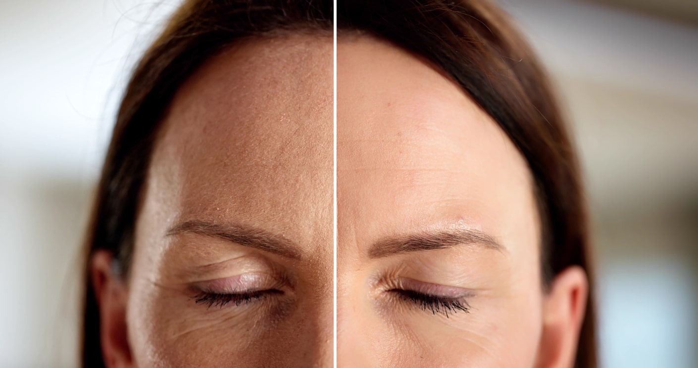 a close up of a person wearing glasses and smiling at the camera