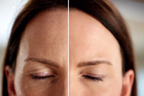 a close up of a person wearing glasses and smiling at the camera